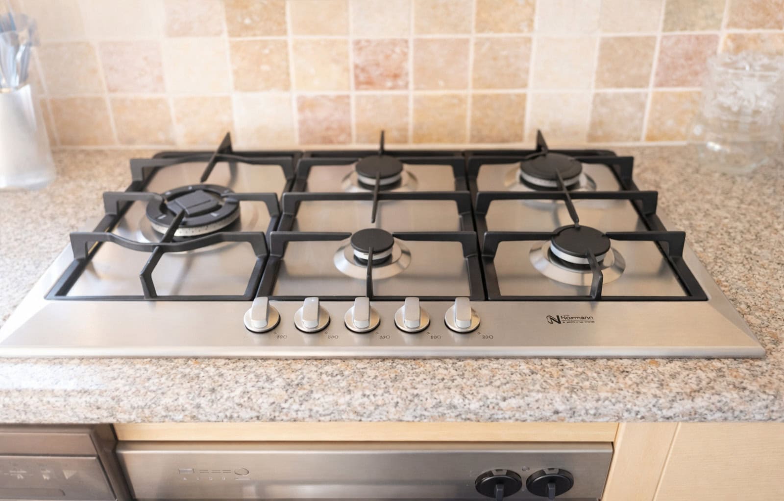 Gas stove with four burners for cooking in a modern kitchen.