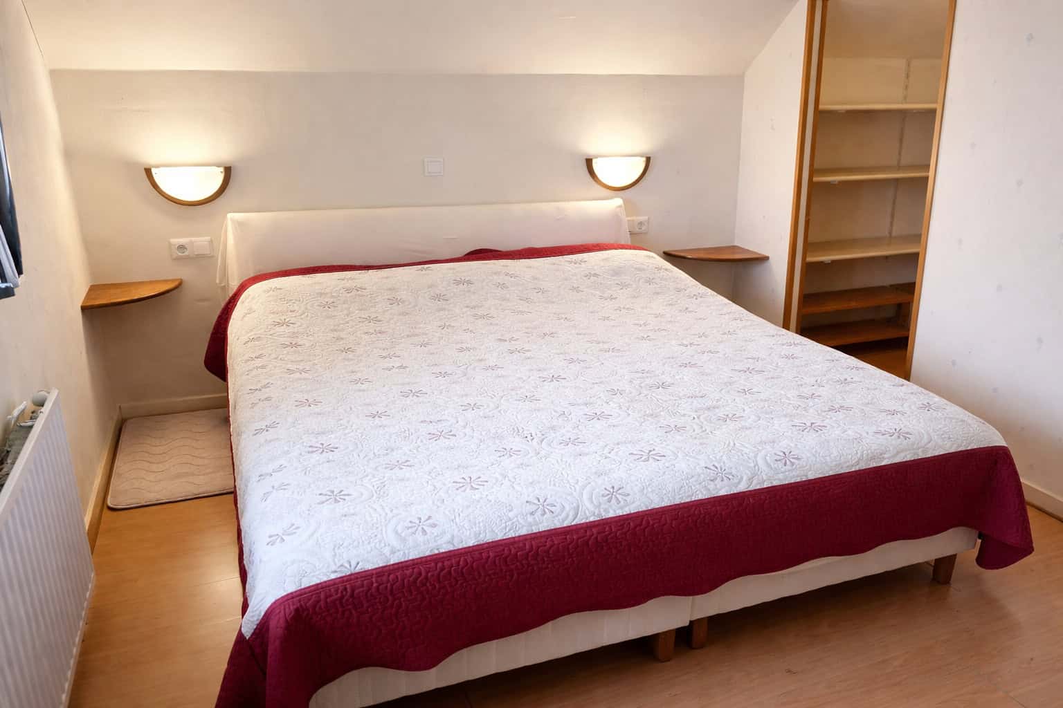 Comfortable bedroom with double bed, soft lighting, and minimalist design.