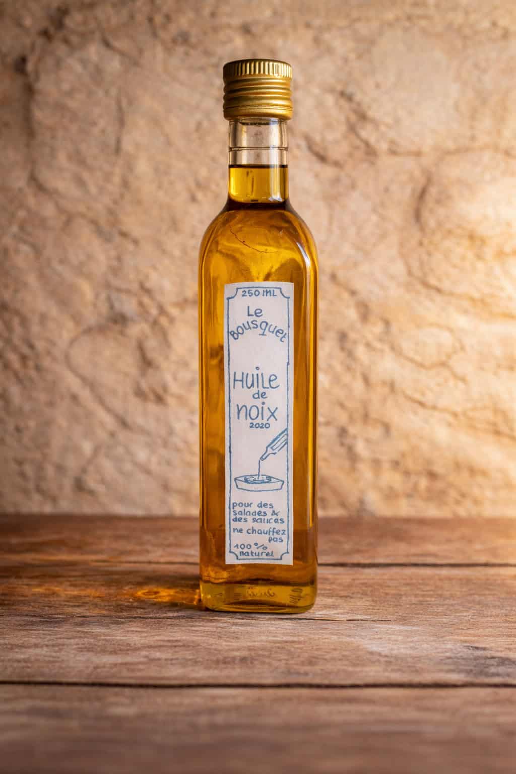 Walnut oil bottle with a handwritten label, showcasing natural and organic product.